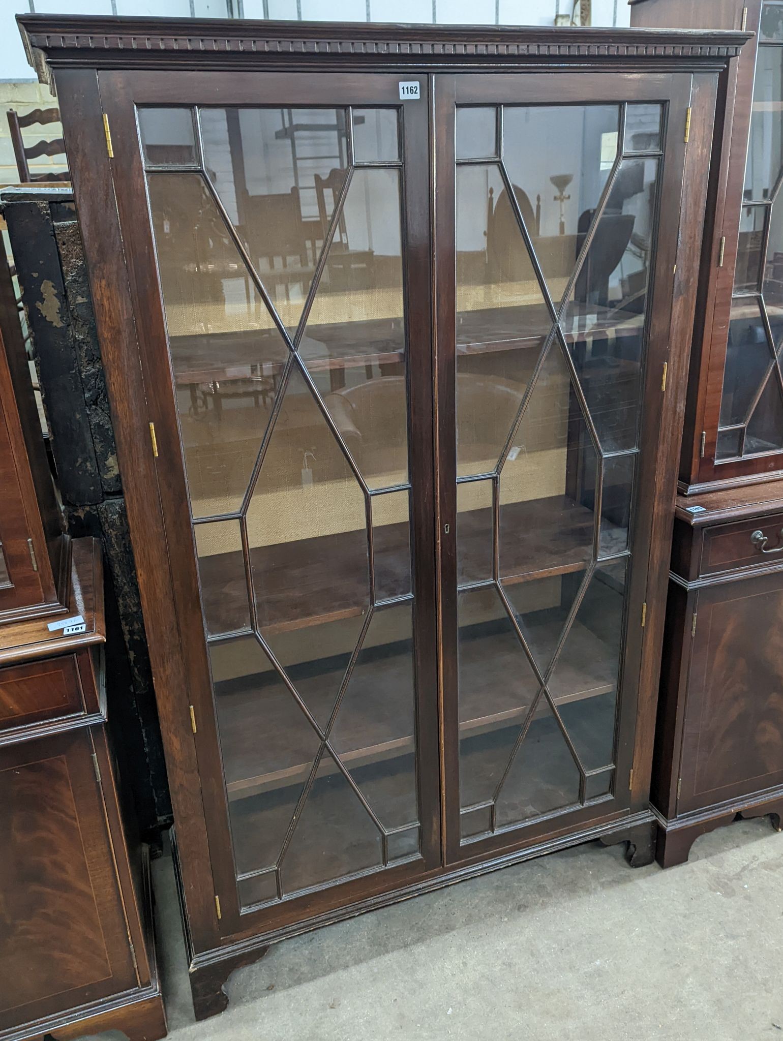 A reproduction George III style glazed mahogany two door display cabinet, width 108cm, depth 40cm, height 172cm
